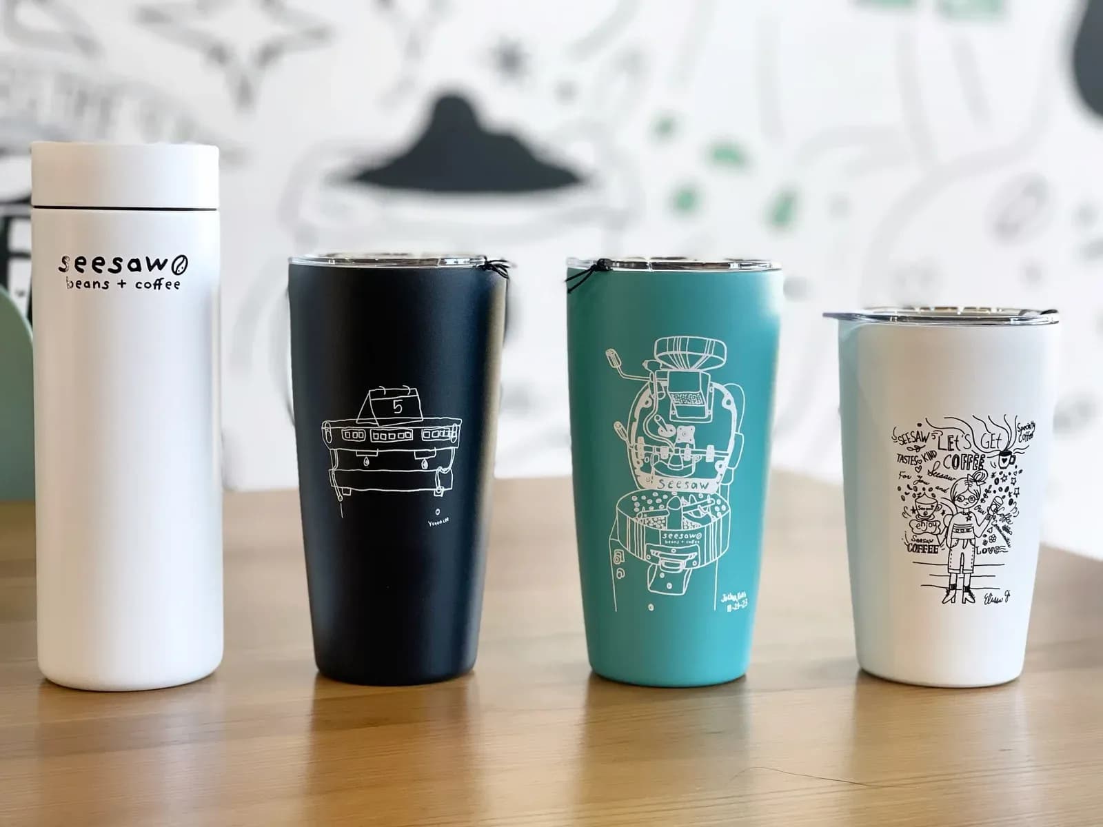 Seesaw insulated tumblers featuring original line-art designs created in the Art Program.