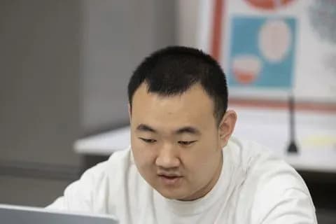 A Seesaw student focused on his laptop during a class.